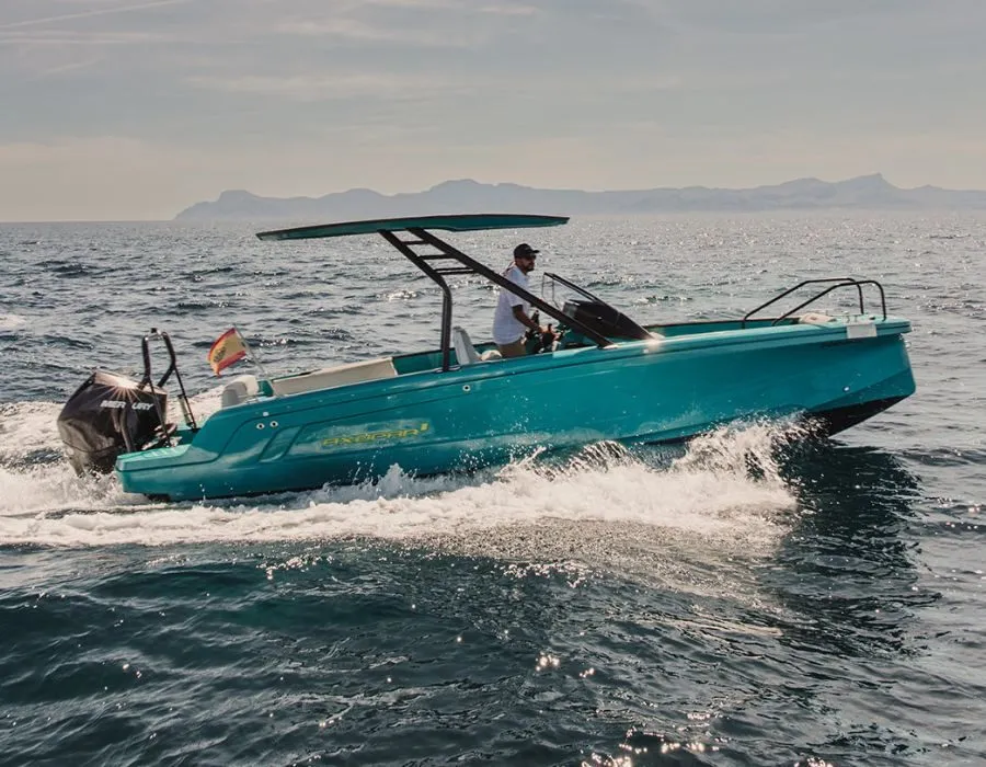 Axopar 22 Spyder with a turquoise hull and T-top cruising at speed