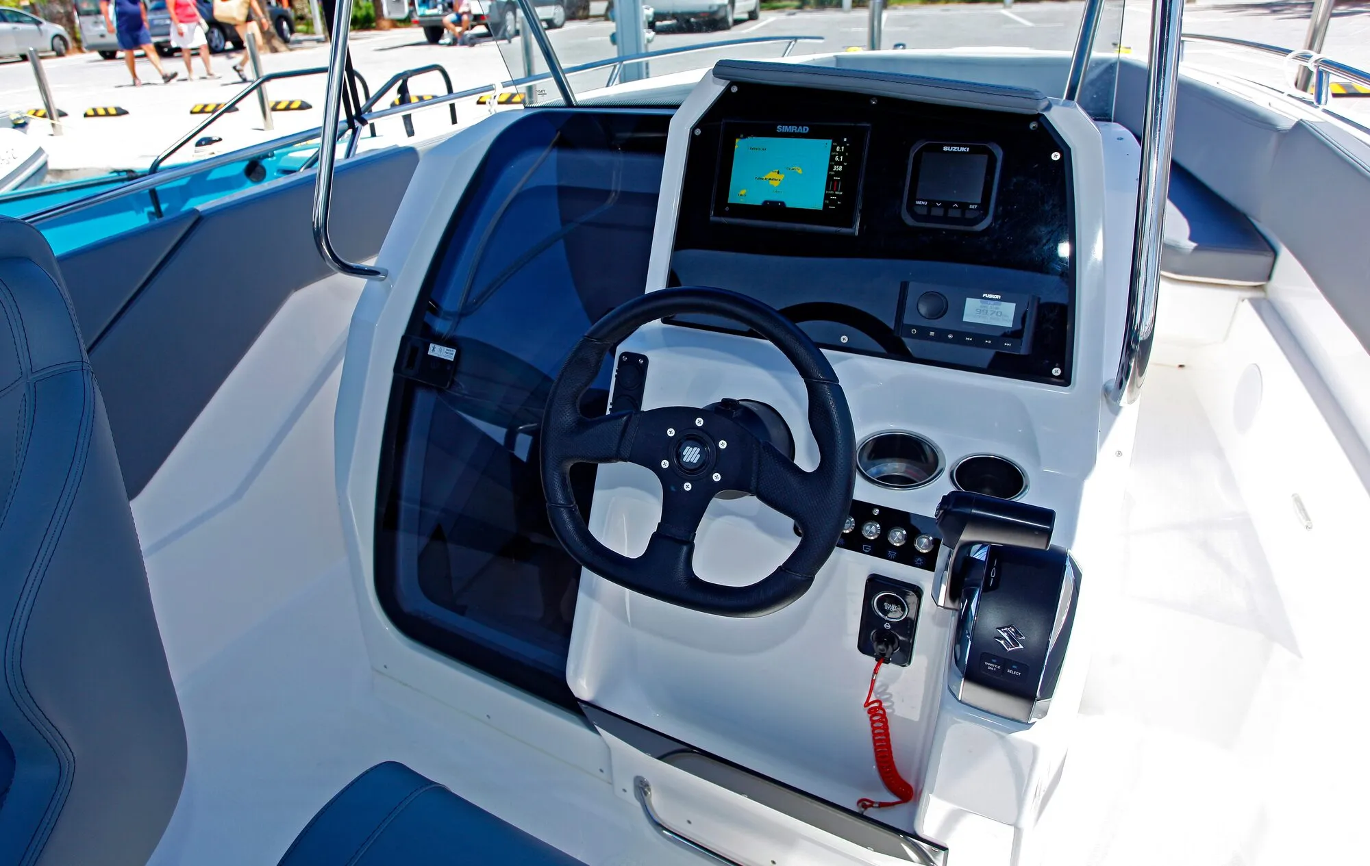 Helm of the Abaris 23 with steering wheel and navigation screens