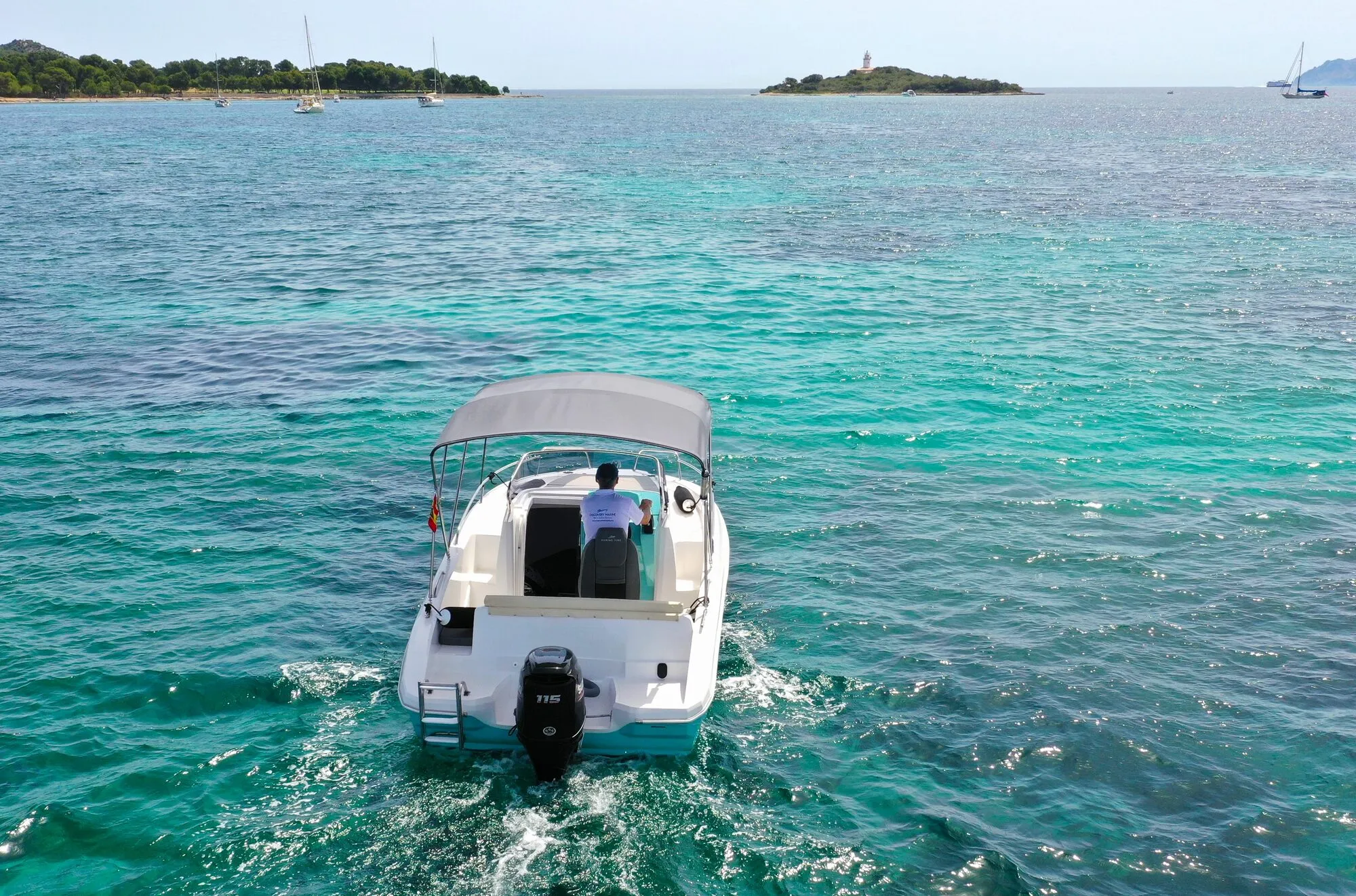 Marine Time 563 seen from behind, heading towards a small island