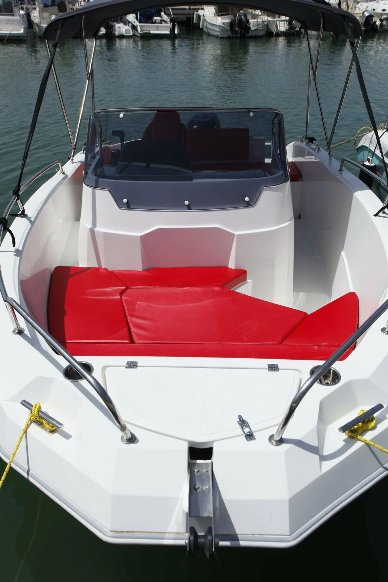Bow of the Marine Time 562 with red cushions, moored in the marina