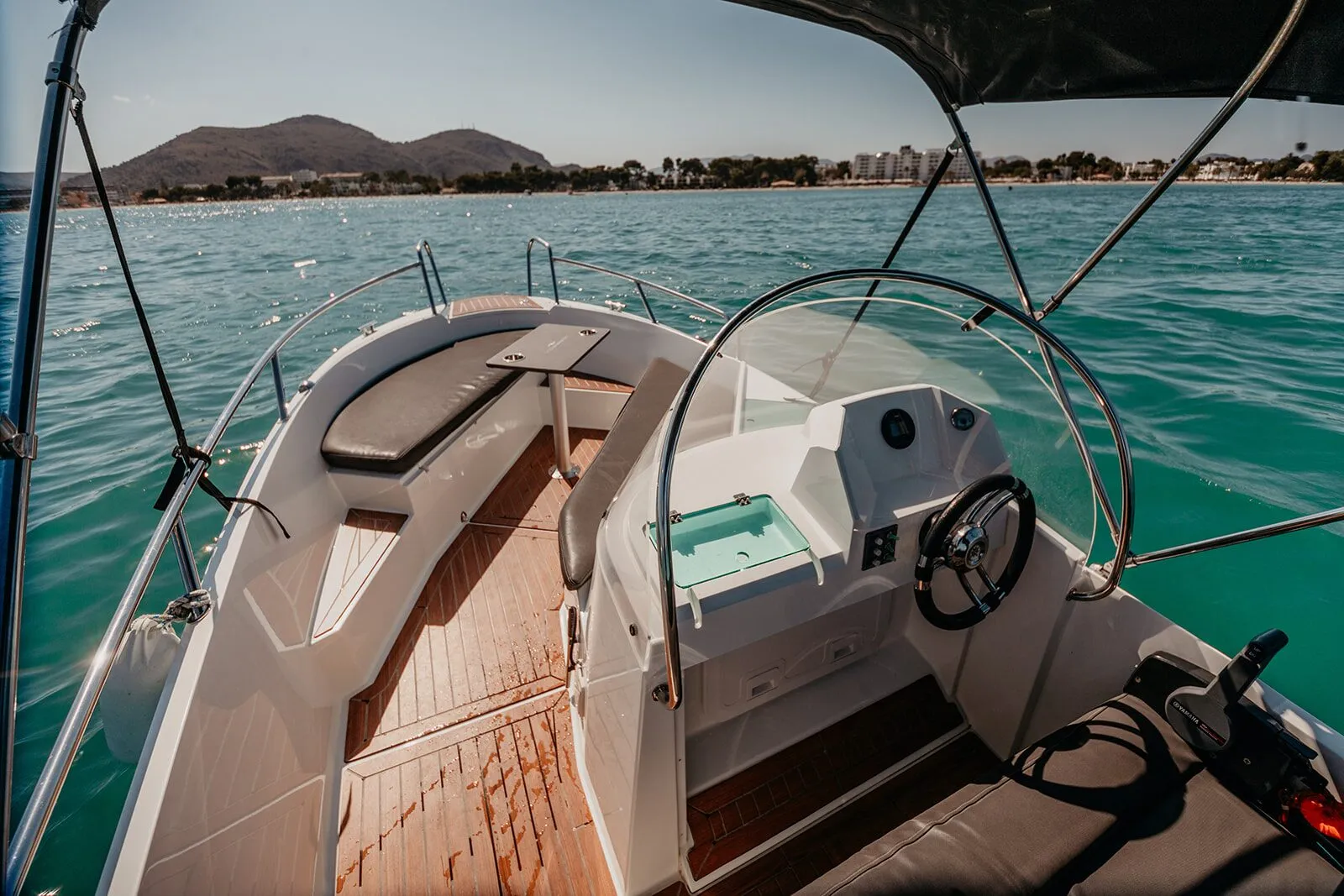 Helm and bow seating of the Ocean Master, with the coast behind