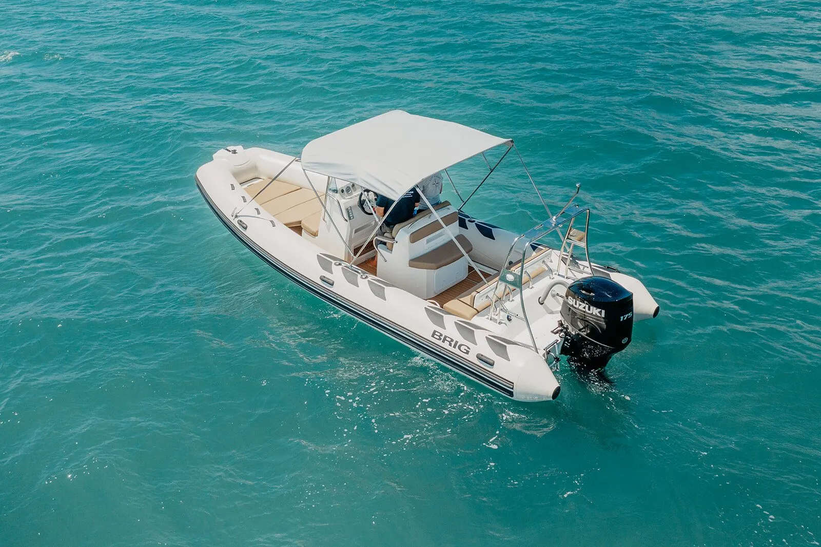 BRIG 700 with its outboard engine on turquoise water, seen from above