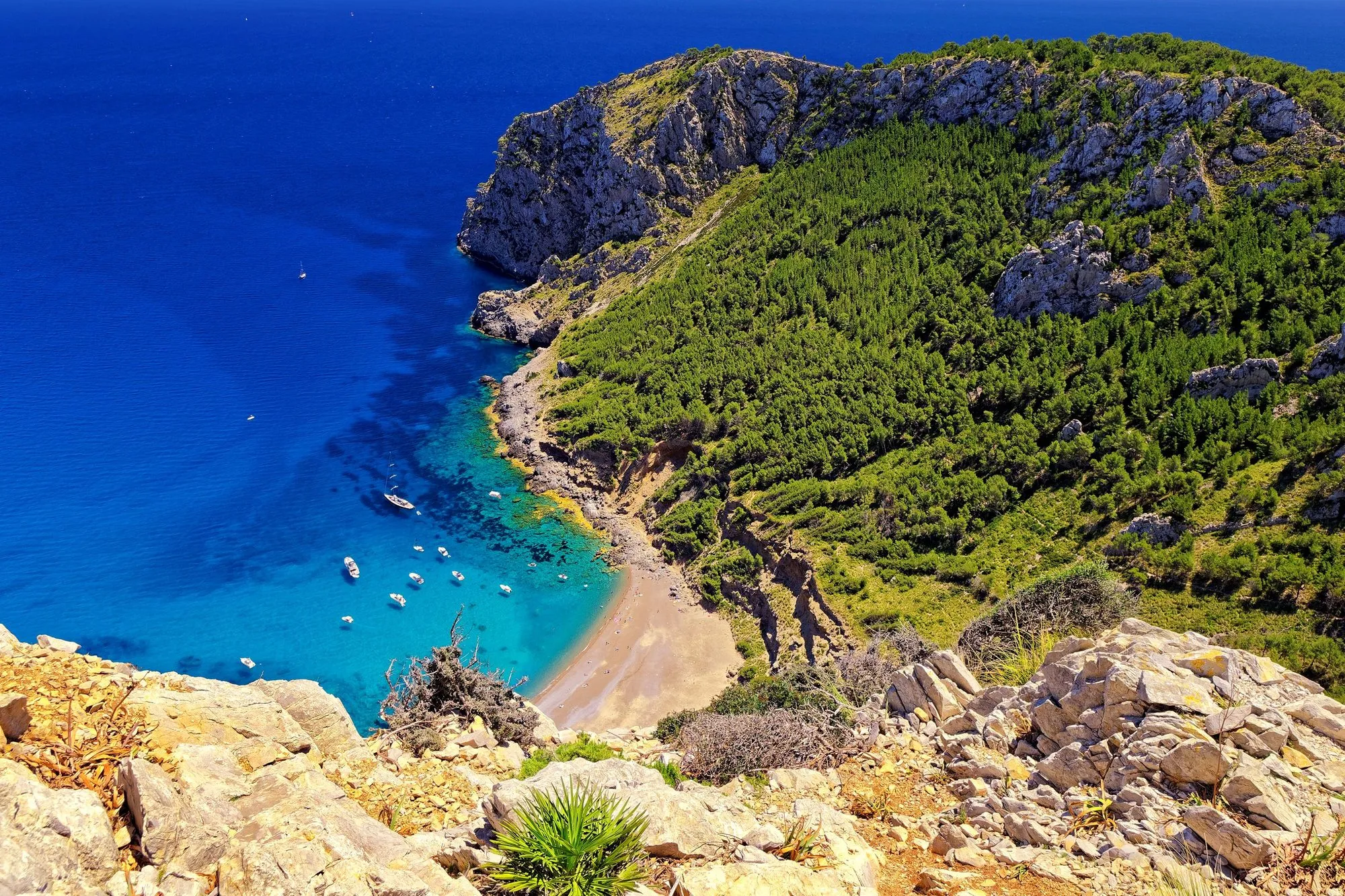 Secluded pebble beach below steep cliffs