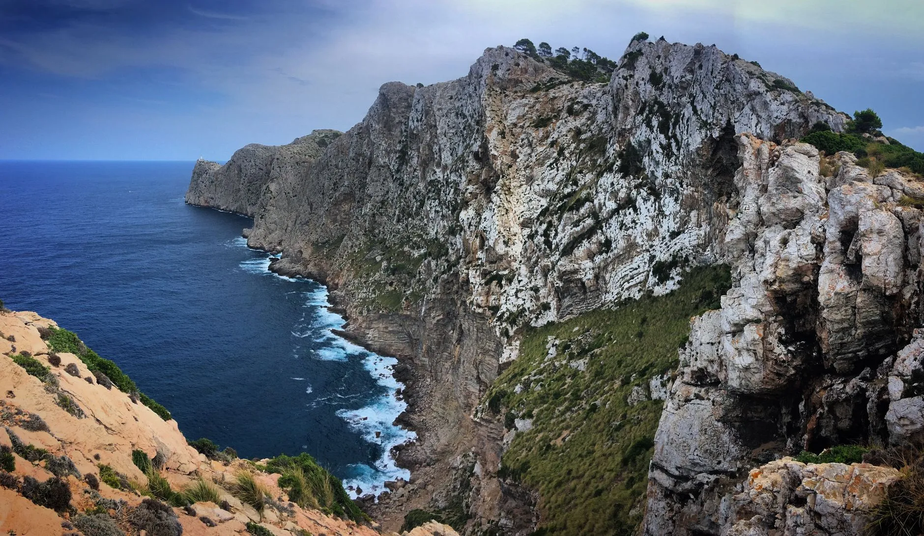 Steep grey cliffs of Cap de Formentor dropping into deep blue water